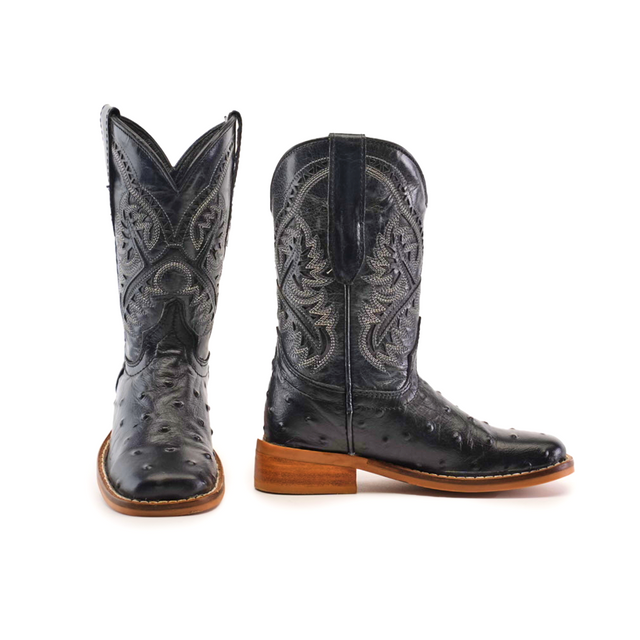 Two Karoo Ostrich Print Black Square Toe cowboy boots with intricate white stitching. Featuring wooden heels, one boot is shown from the front and the other from the side, highlighting their unique texture.