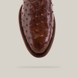 The Exotic Full Quilt Ostrich - Brown - Round Toe shoe features a top view highlighting its unique textured bumps. Its exquisite craftsmanship and leather artistry are accentuated against a plain, light background that draws attention to the detailed design.