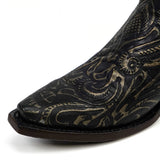 Black cowboy boot with intricate gold embroidery on a white background