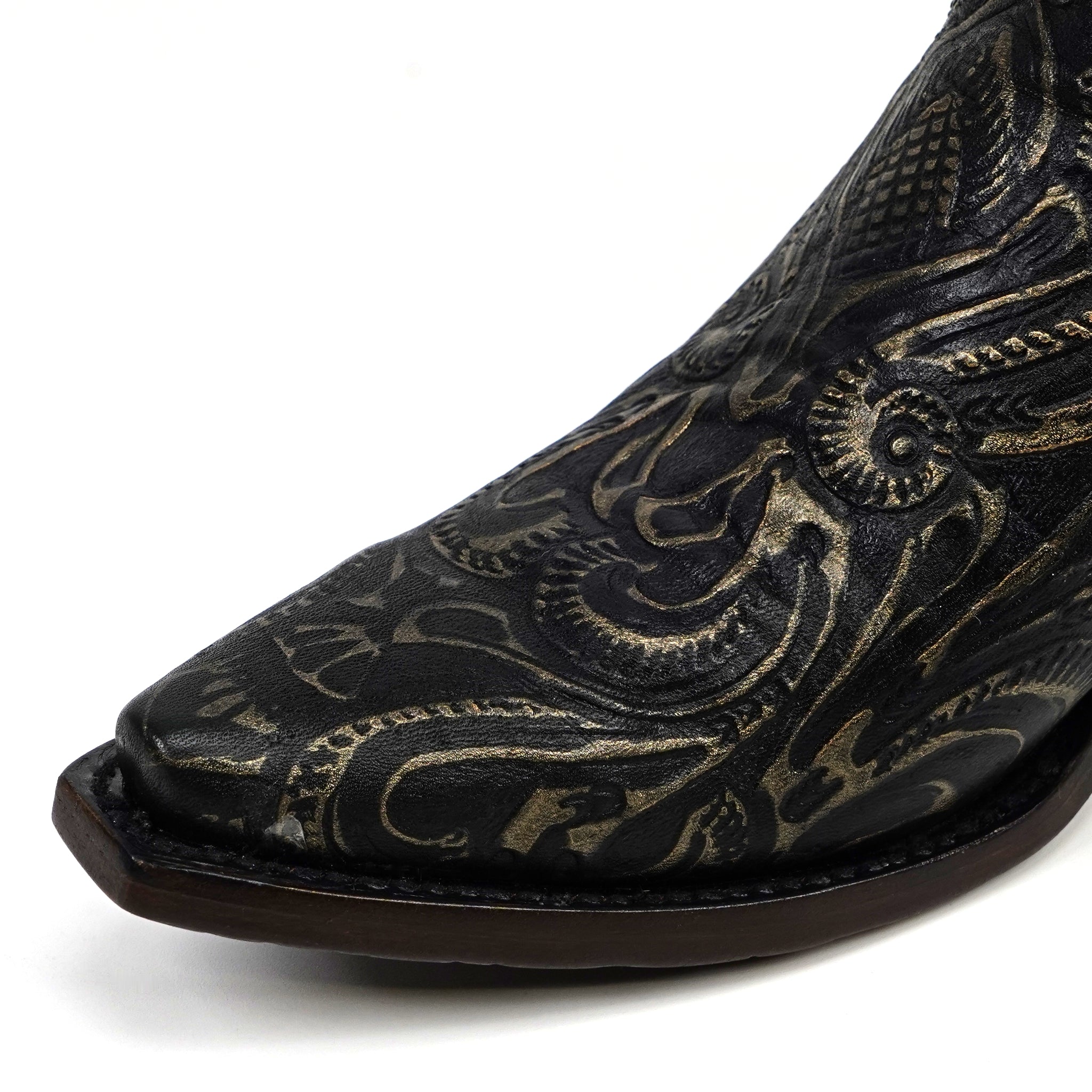 Black cowboy boot with intricate gold embroidery on a white background