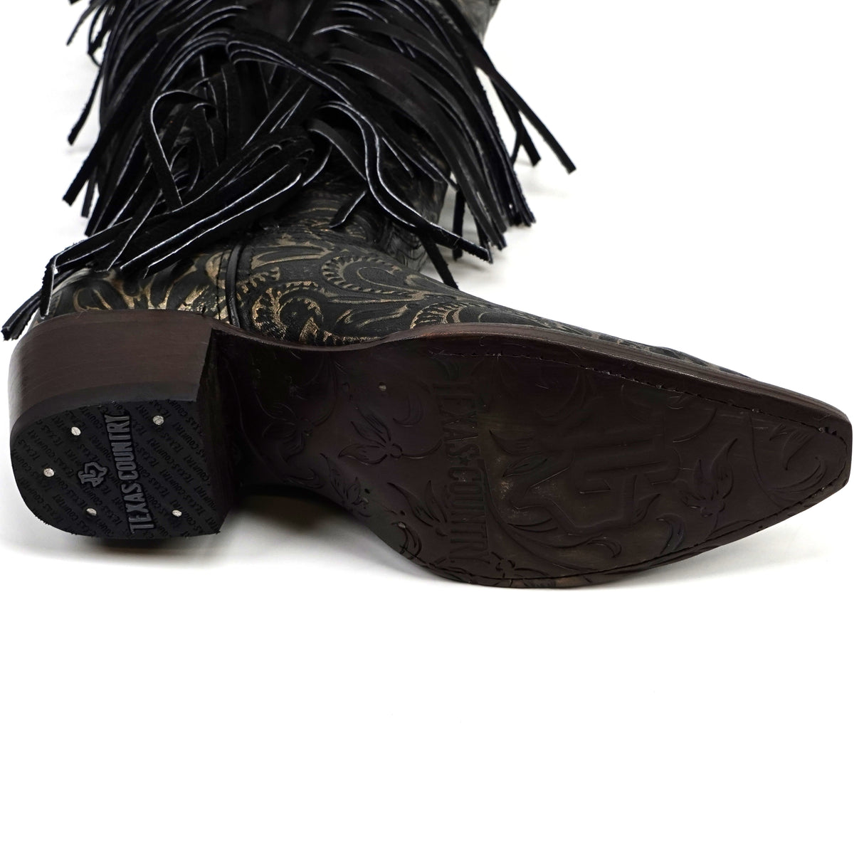 Black fringe cowboy boot with detailed sole on a white background