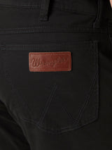 Close-up of Mens Wrangler Retro Slim Fit Straight Leg Pant - 88MWZBK in black, highlighting the back pocket with dark stitching and a brown leather patch embossed with Wrangler, showcasing their premium denim craftsmanship.