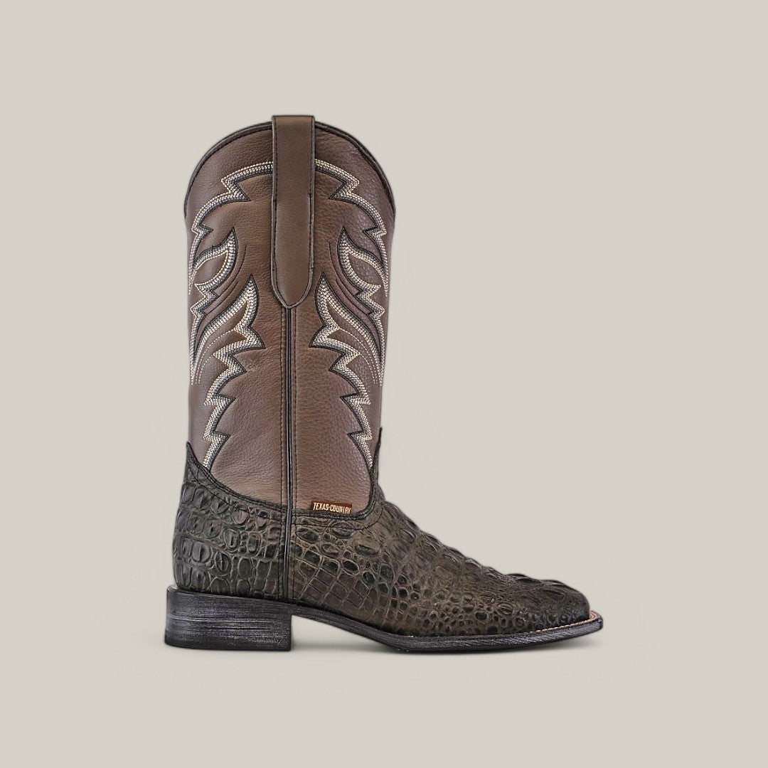 The Alligatoar Head Print Gray - Square Toe cowboy boot features a brown leather upper, white embroidery, textured dark green alligator head print on the lower portion, square toe, low black heel, and a stitched label.