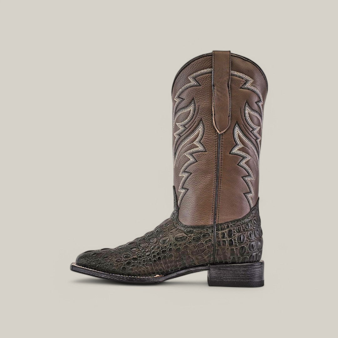 The Alligator Head Print Gray boot features a square toe with detailed stitching on the shaft and a striking alligator head print foot. This Western boot has a medium heel, shown against a plain, light beige background.