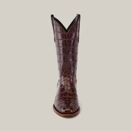 The Exotic Full American Alligator - Brown - Round Toe cowboy boot, crafted from luxury American Alligator leather, displays a textured finish. Its elegant design includes a classic round toe and subtle heel on a plain light gray backdrop.