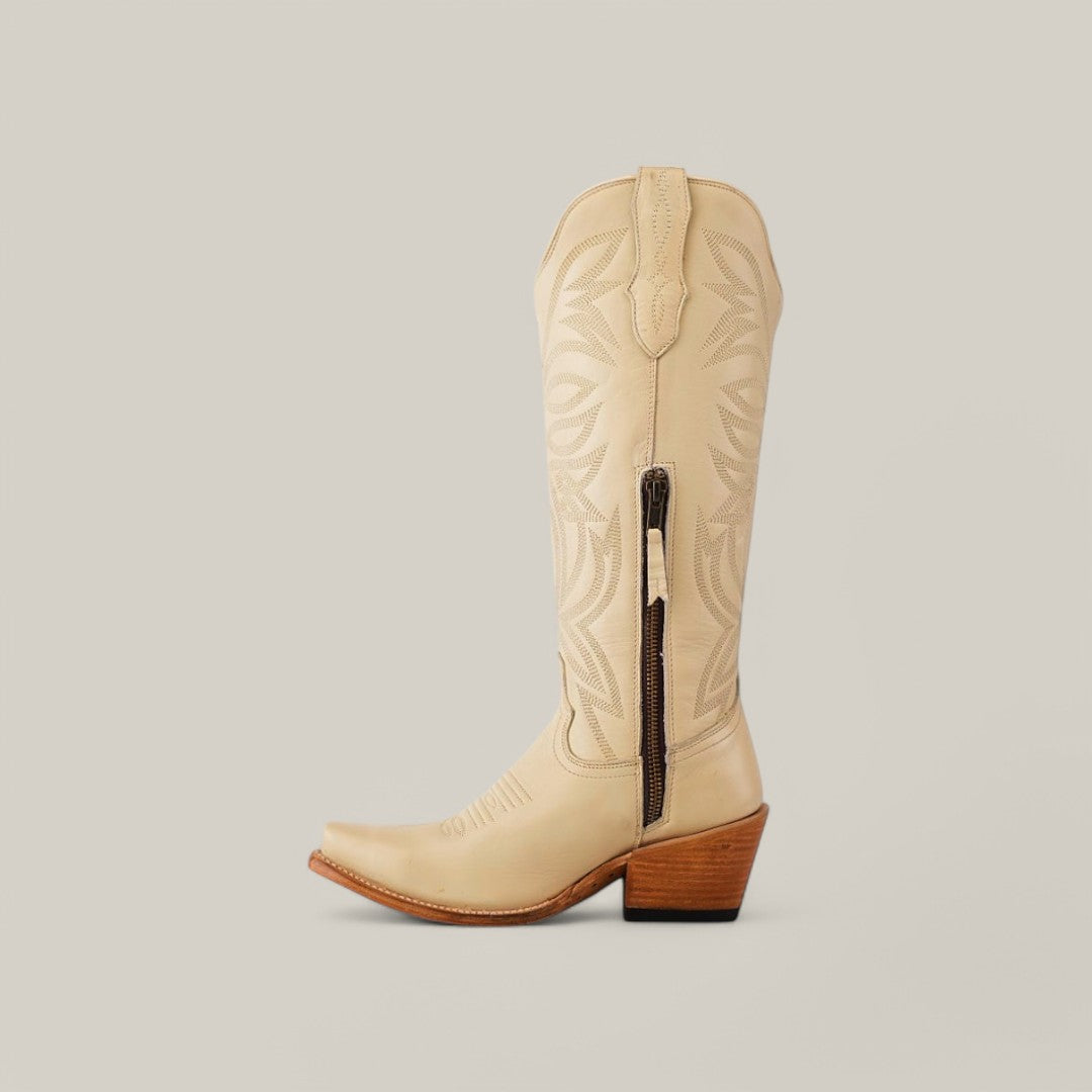 The Kellie Bone Leather Sole boot, featuring a snip toe, side zipper, intricate stitching, and wooden heel, is displayed against a plain light gray background.