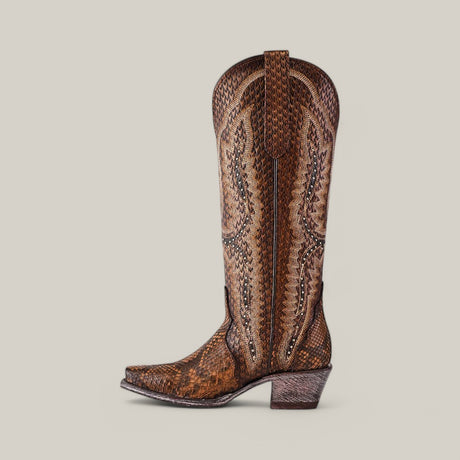 A side view of the Athala Exotic Python Tamarindo boot displays premium python leather in a detailed brown and tan pattern. This tall shaft, snip-toe boot has decorative stitching and a medium-height heel against a plain beige background.