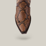 The Athala Exotic Python Tamarindo boot flaunts a snip toe crafted from premium python leather, showcasing a detailed pattern of dark and light brown scales that emphasize its Western roots against a plain light gray backdrop.