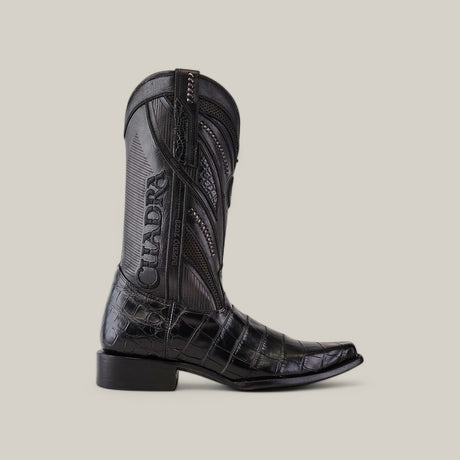 The Alligator Belly Black - Narrow Square Toe - IMPERIO cowboy boot boasts a stylish narrow square toe, textured pattern, intricate stitching, Cuadra branding on the shaft, and a low heel against a plain backdrop.