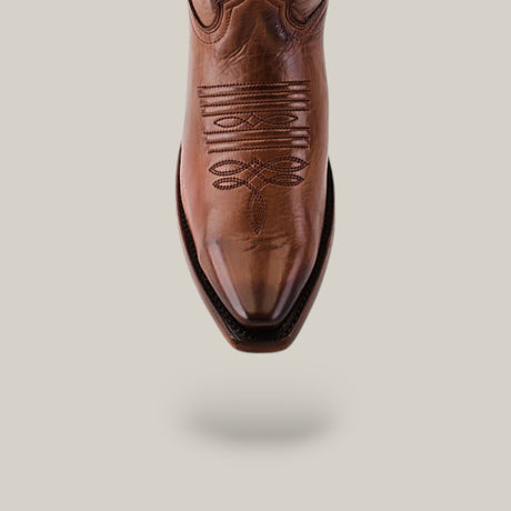 A brown Miranda Clayton boot with a leather sole and mid shaft, showcases intricate stitching on the upper. It features a snip toe and smooth leather finish, all set against a light gray background.