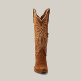 The Kellie Suede Caramel Leather Sole cowboy boot showcases a snip toe and intricate white stitching on its tall shaft, all elegantly set against a plain backdrop.