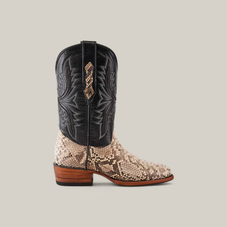 The Exotic Python - Natural - Round Toe is a stylish cowboy boot featuring luxury natural python leather, a black embossed upper, and a light brown snake-patterned lower. It comes with a stacked wooden heel and pull straps on the sides, set against a plain gray background.