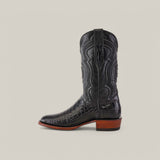 The Exotic American Alligator Belly boot is a black roper toe design featuring textured leather and detailed shaft stitching, complemented by a brown wooden heel and sole. Set against a light beige background, it exudes elegance with its exotic materials.