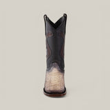 Front view of the Exotic Python - Diamond - Natural cowboy boot, featuring a black upper and textured tan lower in elegant python leather with decorative stitching and a square toe, set against a plain gray background.