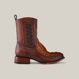 The Exotic American Alligator Tail - Fawn - Narrow Square Toe boots feature handcrafted brown leather with intricate black checkerboard detailing, a textured front pattern, and are made from exotic American alligator tail leather. They have a short heel and stand elegantly against a plain background.