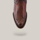 Close-up of the Exotic American Alligator - Europe Fawn - Round Toe boot, highlighting its rich brown texture and refined style from above with a soft shadow on a solid light background.