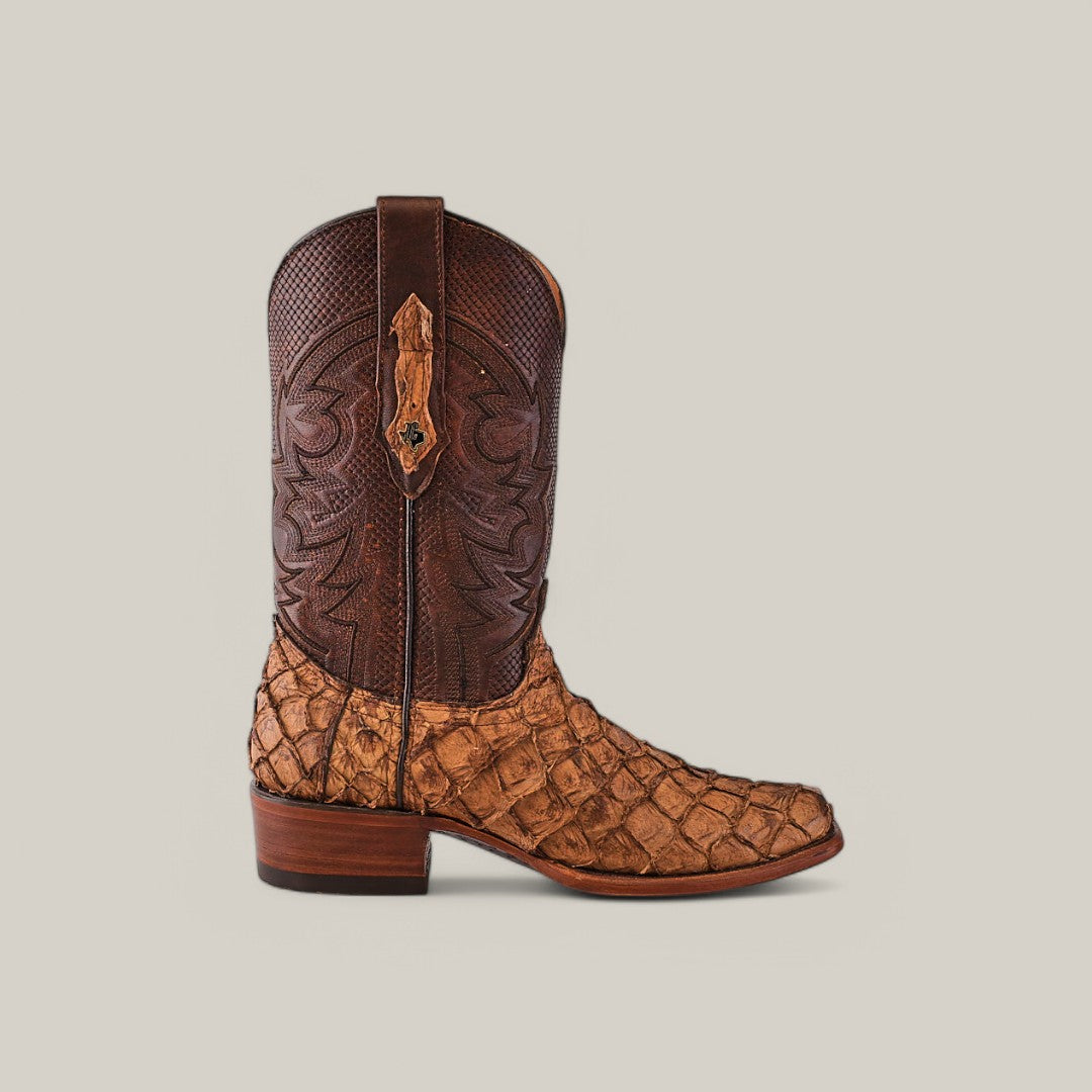 The Exotic Pirarucu Fish - Matte Orix boot features a brown leather upper and textured tan lower with intricate stitching. Crafted from Pirarucu leather, it has a narrow square toe, slight heel, and pull straps on each side.