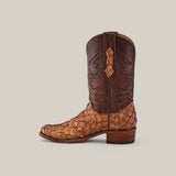 A brown cowboy boot with a textured alligator-like base and detailed stitching on the shaft features a unique Matte Orix finish, known as Exotic Pirarucu Fish, and is set against a light gray background.