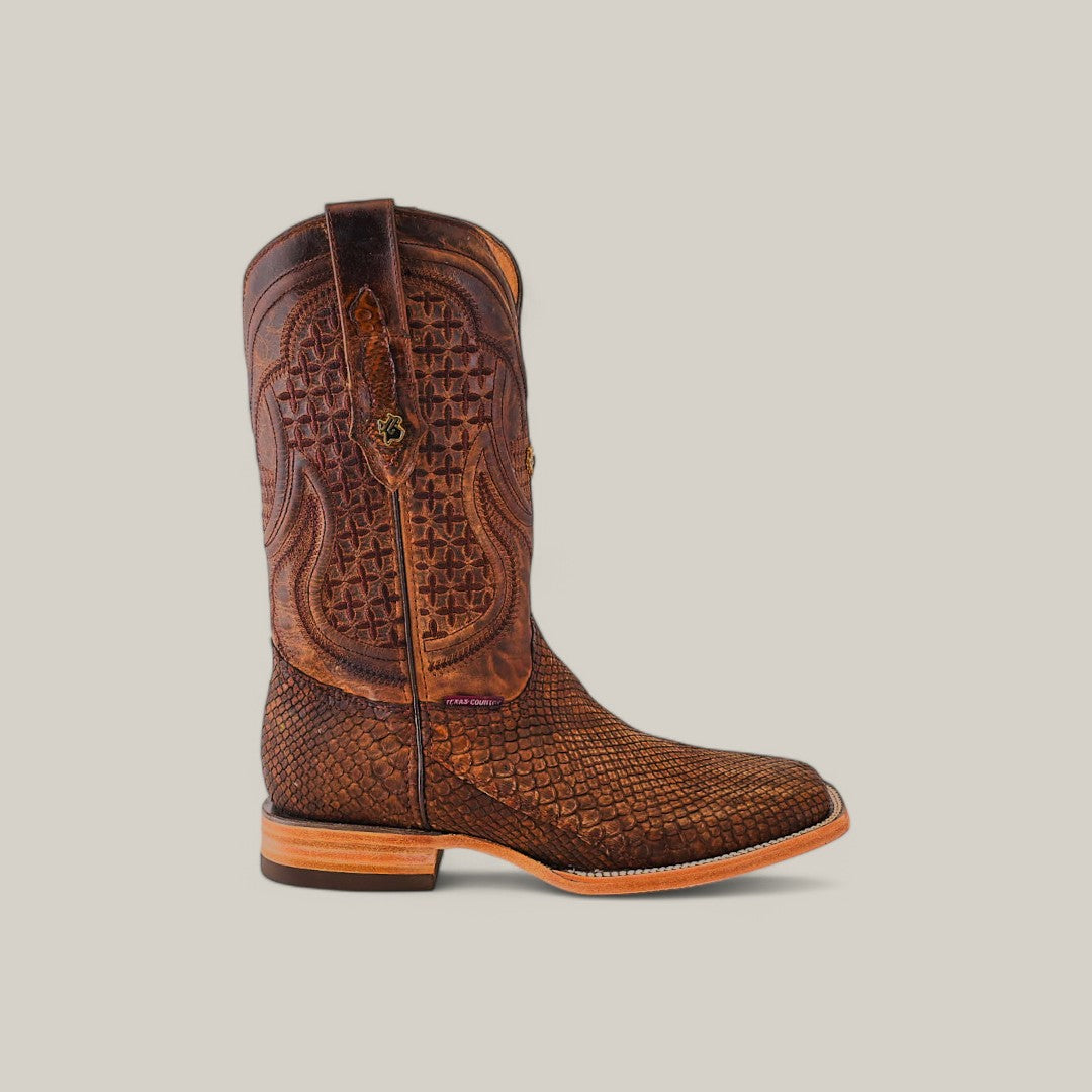 The Exotic Python - Tamarindo - Square Toe is a tall, brown cowboy boot made from exotic python leather, featuring intricate embossed patterns and a slightly raised heel. Its textured lower portion with decorative stitching on the shaft enhances its charm against a neutral background.