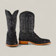 The Exotic Patchwork Pirarucu Fish - Matte Black - Square Toe boots feature black textured leather, white stitching on the shaft, eco-friendly materials, brown soles, and low heels. Displayed on a light gray background.