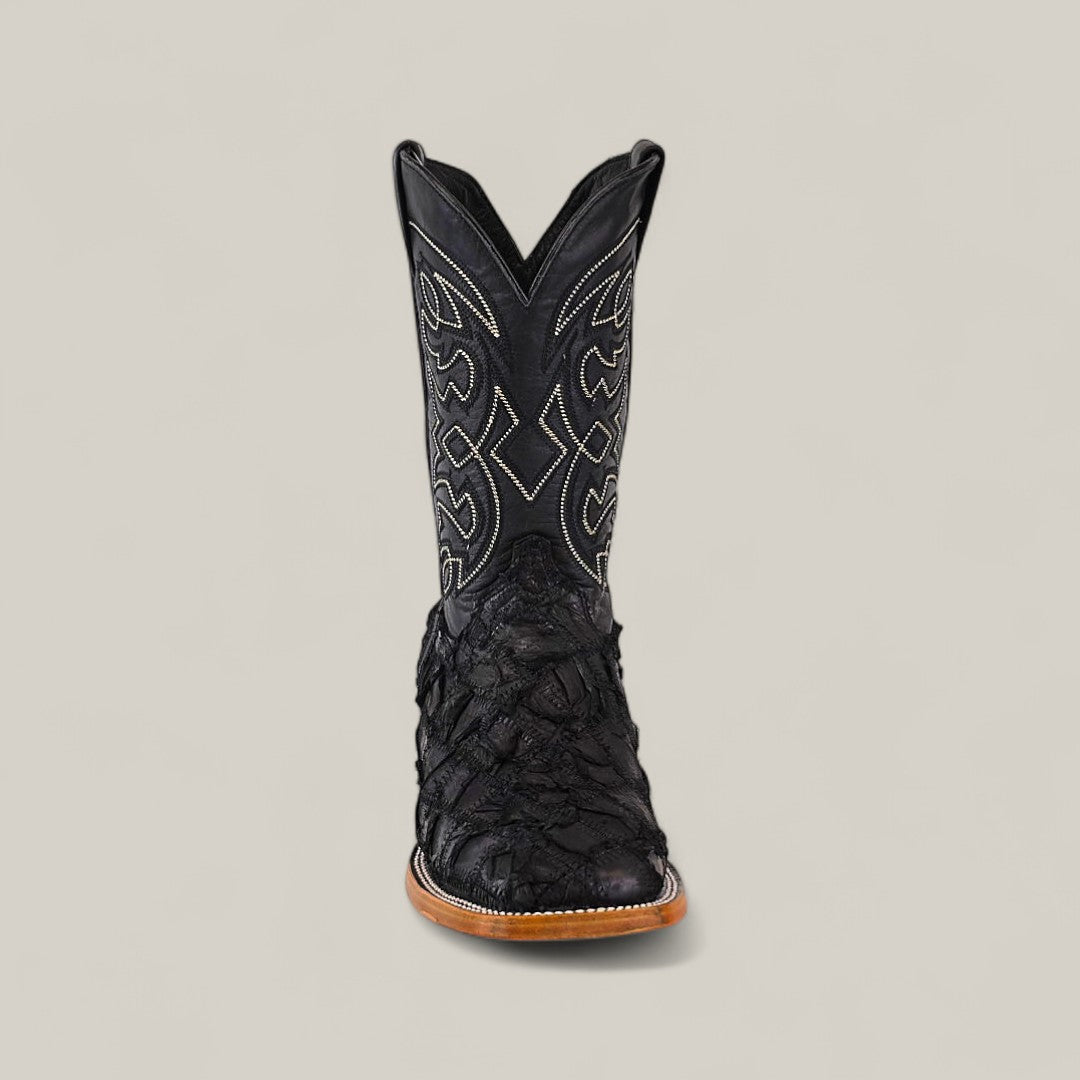 The Exotic Patchwork Pirarucu Fish - Matte Black - Square Toe boot features intricate shaft stitching and textured pirarucu leather on the foot, displayed facing forward on a plain light gray background.