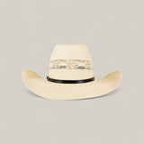 The 50x Brazil Straw Hat is a light beige, wide-brimmed summer hat with ventilation holes around the crown and a black band, shown against a plain light background for stylish sun protection.