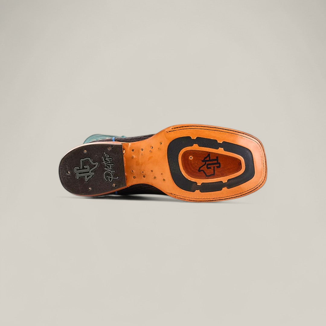 The image displays the sole of an Exotic Caiman Horn Back - Dark Brown - Square Toe boot, featuring leather and rubber construction with a signature logo and initials by the heel, set against a plain light background.