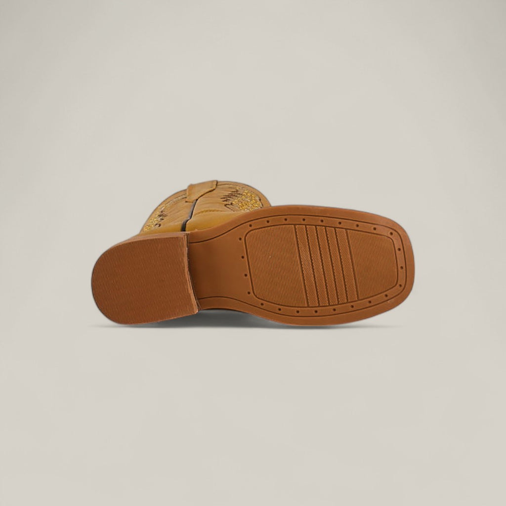Close-up of the sole on Orion Yellow - Square Toe - Kids Boots, featuring a smooth brown rubber bottom, slightly raised heel, and decorative side stitching. Perfect addition to girls’ boot collections with a plain Orion Yellow background.