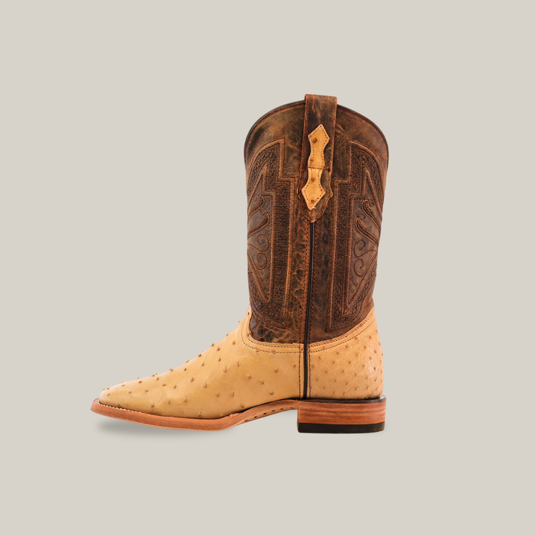 The Exotic Full Quilt Ostrich - Orix boot, made from tan ostrich leather, has a dark brown embroidered shaft. With its square toe and sturdy heel, it seamlessly combines elegance and durability, capturing the timeless allure of classic cowboy boots.