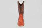 The Exotic Caiman Horn Back - Brandy - Square Toe boot, featuring a brown textured shaft and reddish patterned foot, is displayed facing forward on a plain light gray background.