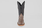 The Exotic Caiman Horn Back - Serpentine - Square Toe boot is shown from the front, displaying a textured reptile-like lower, dark stitched shaft, and light brown sole—a classic western look against a plain background.