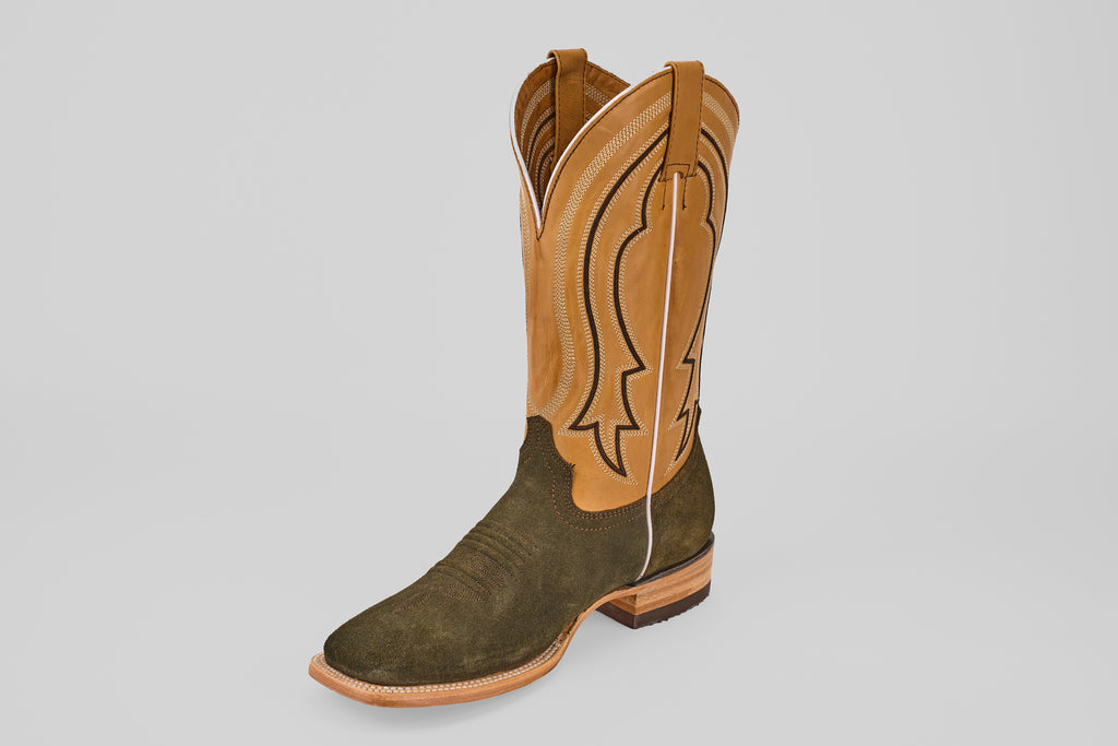 The Prime Suede Green Olive - Square Toe boot features a dark green foot and a tan, stitch-detailed shaft, displayed against a plain light gray background.