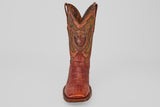The Exotic Alligator Tail - Brick - Square Toe boot features brown textured leather, decorative stitching, and a red and gold crest on the front shaft, displayed against a plain light background.