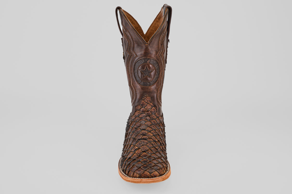 The Exotic Pirarucu Fish - Brown - Square Toe boot features a textured, woven lower and star emblem on the upper shaft, shown from the front on a white background—ideal for exotic leather boot enthusiasts.