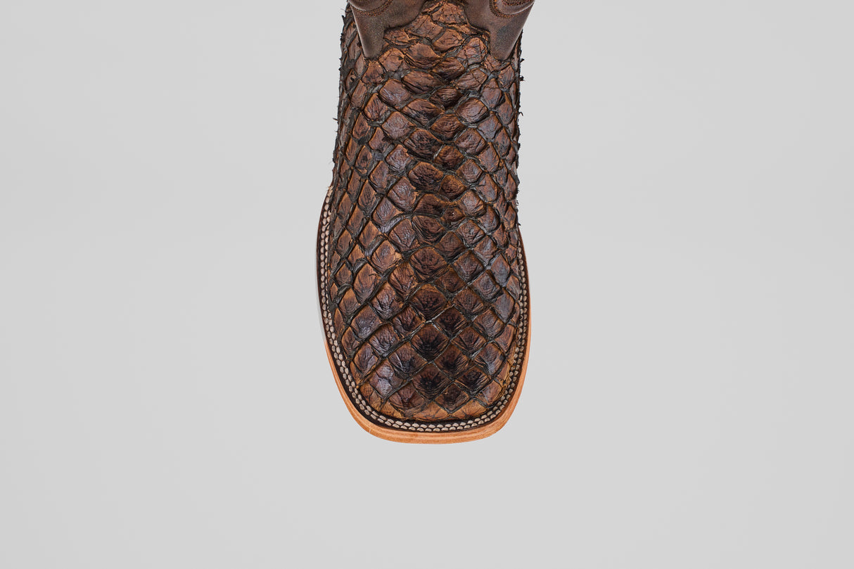 A close-up, top-down view of the Exotic Pirarucu Fish - Brown - Square Toe boot highlights its textured exotic leather, square toe design, and detailed stitching along the tan leather sole.