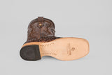 The Exotic Pirarucu Fish - Brown Square Toe boot, shown on its side, highlights a tan sole with Texas Country branding and a black embossed heel—ideal for those seeking unique square toe boots.