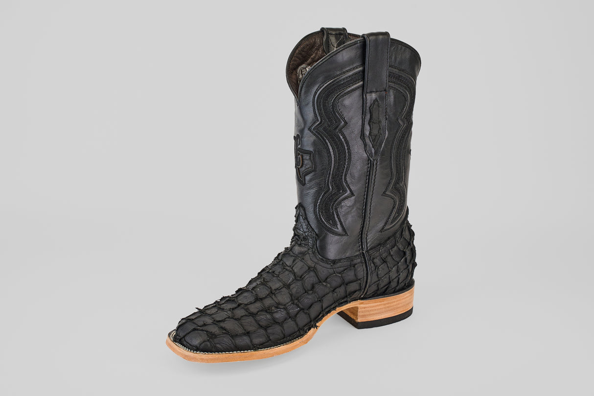 The Exotic Pirarucu Fish - Matte Black - Square Toe features a scale-textured foot, smooth stitched leather upper, and is finished with a light tan sole and wooden heel for a bold, elegant look.