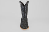 A single Exotic Pirarucu Fish - Matte Black - Square Toe boot, featuring textured leather and a tan sole, is shown upright and facing forward against a plain gray background.