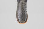 A close-up of the Exotic Full Quilt Ostrich - Gray - Square Toe boot, showing its gray full quilt ostrich leather, square tip, and decorative stitching along the sole's edge.