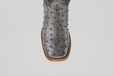 A close-up of the Exotic Full Quilt Ostrich - Gray - Square Toe boot, showing its gray full quilt ostrich leather, square tip, and decorative stitching along the sole's edge.