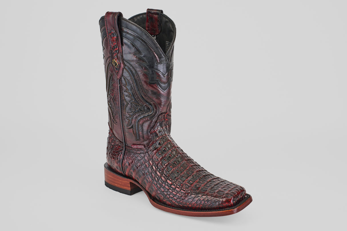A single Exotic Caiman Hornback - Blackcherry cowboy boot with a Rodeo toe, detailed stitching, and a wooden heel is displayed against a plain light gray background.