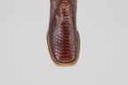 Top view of the Tanner - Brown - Square Toe cowboy boot, showcasing its textured, scaly snakeskin pattern and detailed stitching along the light tan sole.