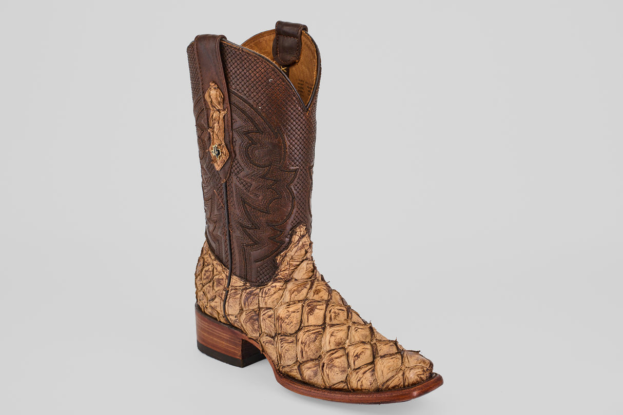The Conor - Matte Orix - Narrow Square Toe is a cowboy boot featuring a brown, textured leather shaft and a tan, scaled Pirarucu leather foot with a low stacked heel and narrow square toe.