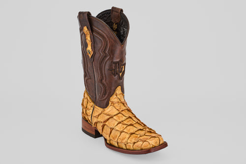 The Conor - Buttercup - Rodeo Toe cowboy boots feature a dark brown leather upper and a light tan, scale-textured lower section made from fish leather, showcased against a plain gray background.