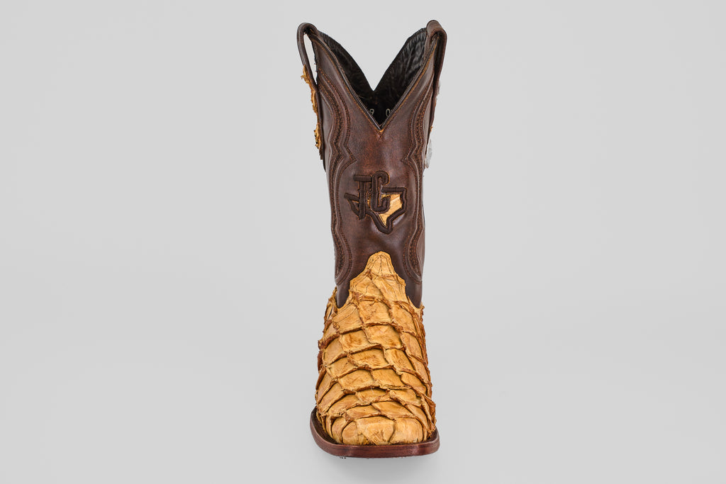 The Conor - Buttercup - Rodeo Toe boot features brown leather uppers and tan, textured reptile skin on the lower part, displayed from the front against a plain gray background.