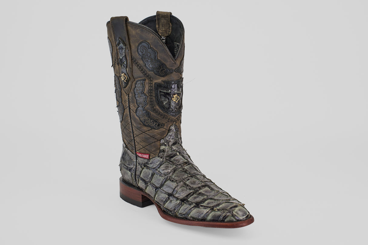 The Conor - Charcoal - Roper Toe cowboy boot for men features a textured dark gray fish leather pattern, brown shaft with intricate stitching, roper toe, and wooden heel, shown on a plain light gray background.