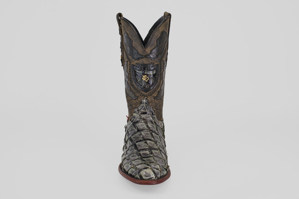 The Conor - Charcoal - Roper Toe is a single ornate cowboy boot made from textured fish leather, featuring a roper toe and bold red sole, displayed upright on a plain light gray background.