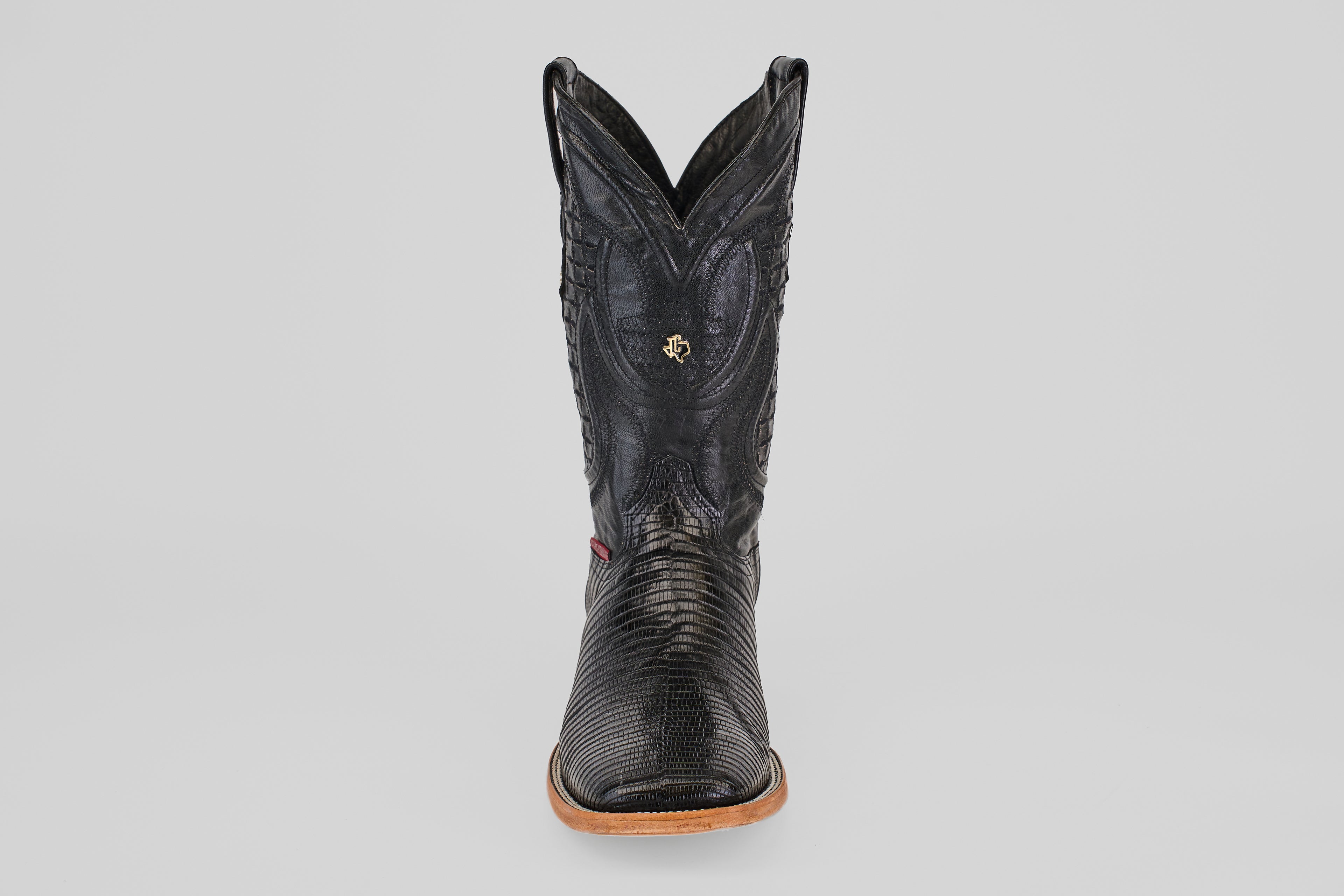 The Blaze – Black – Square Toe cowboy boot, made from genuine lizard leather with a tan sole, is displayed front-facing against a plain light gray background.