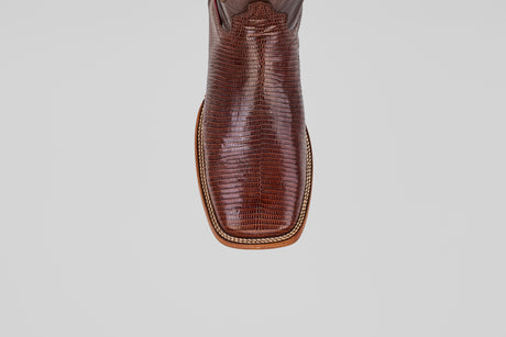 A close-up, top-down view of the toe of the Blaze – Brown – Square Toe boot showcases lizard-textured leather and decorative stitching, highlighting the rugged elegance of this classic western style.