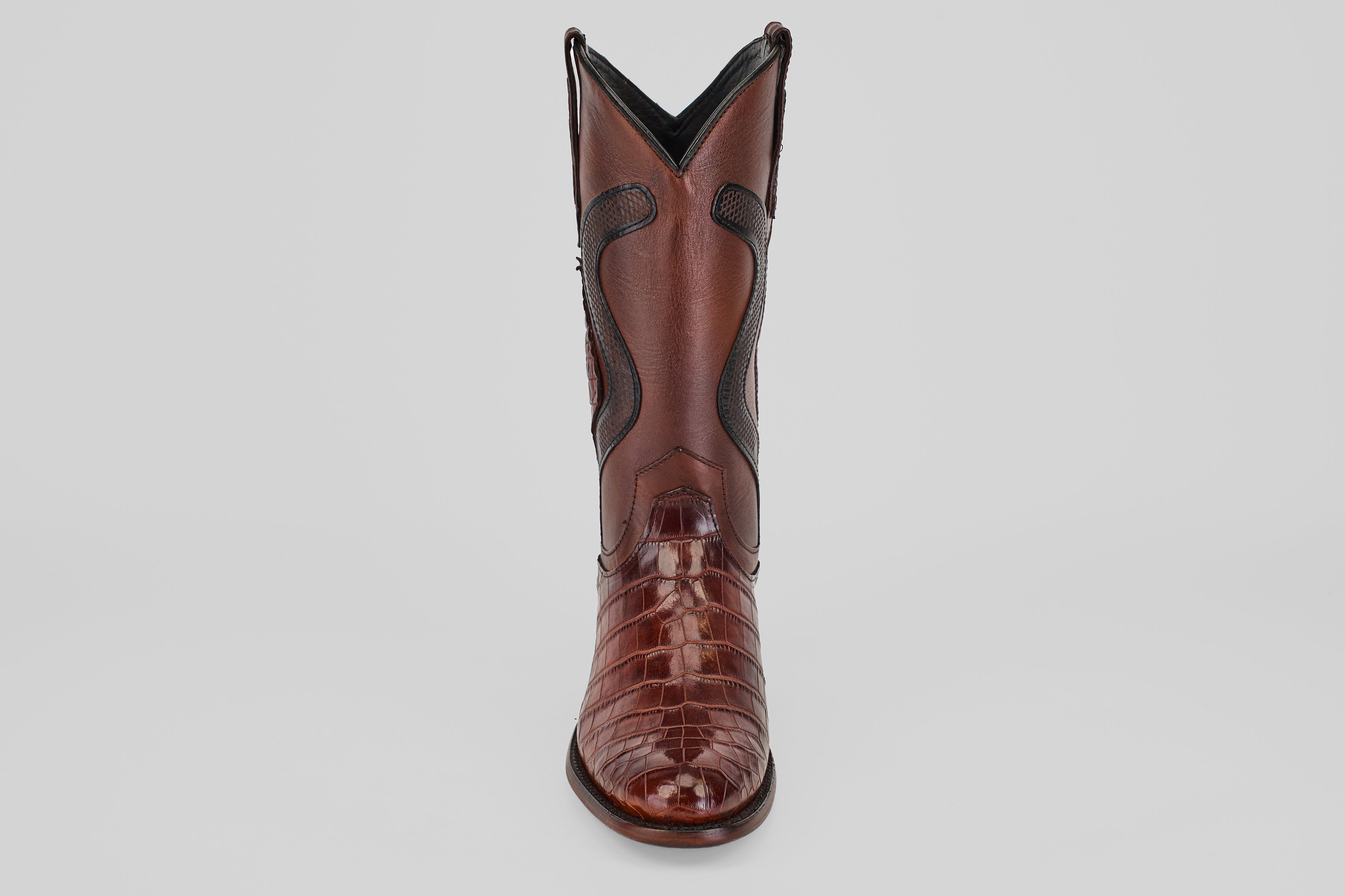 The James Platimun - Dark Cogñac boot with a glossy, textured finish and classic roper toe stands upright, facing forward against a plain light gray background.